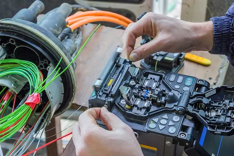 Technician organizing structured fiber cabling in Dubai