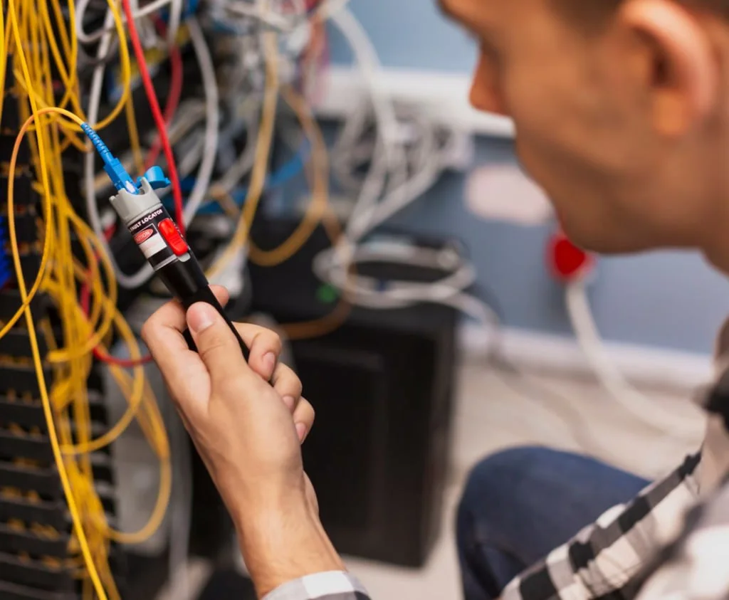 Technician working on fiber cable installation tools