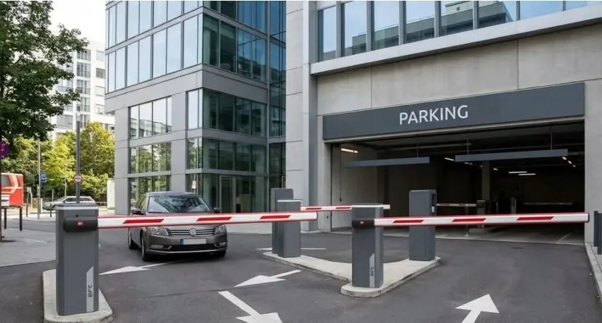 Boom barrier controlling vehicle entry at a building parking ramp