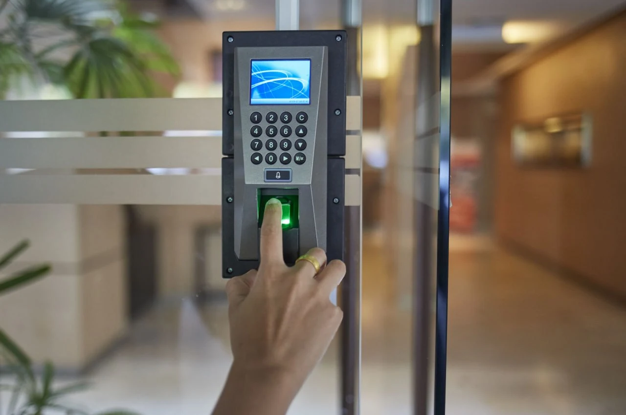 Wall mounted fingerprint attendance terminal at a company entrance